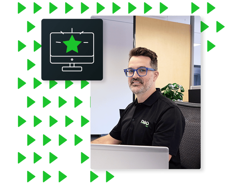 Neo customer success specialist smiling at computer, illustrating Neo’s personalized support service designed to maximize carrier satisfaction.