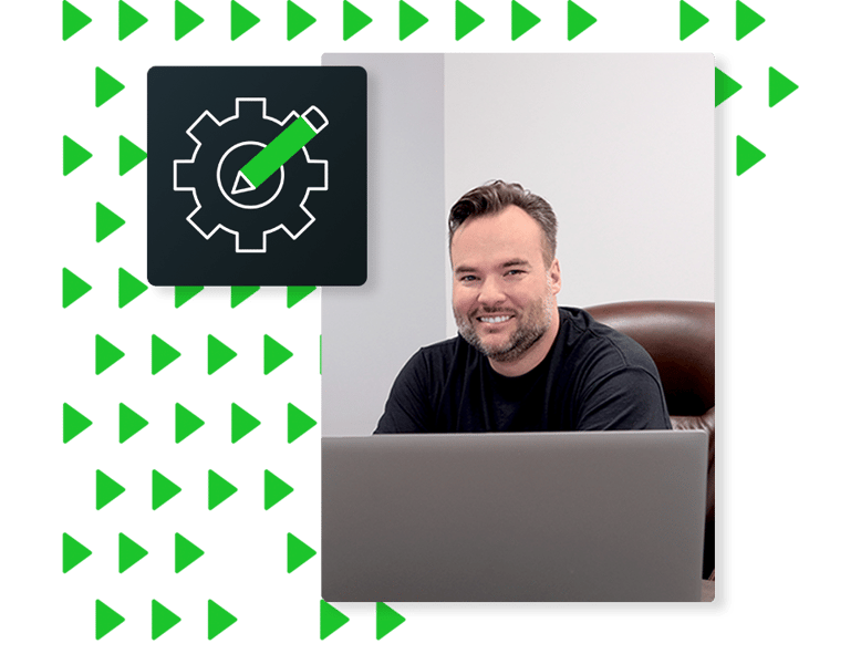 Neo developer smiling at laptop, illustrating custom development service enabling Neo TMS to adapt to the unique needs of transport companies.